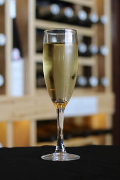 A glass of sparkling white wine