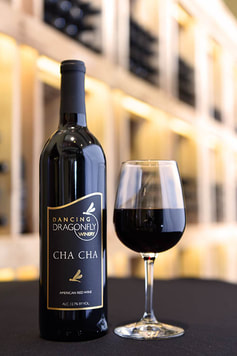 Picture of a bottle and a glass of Cha Cha red wine